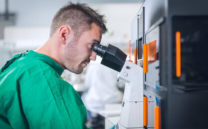 Ein Schüler schaut durch das Mikroskop im BioMems Lab der TH Aschaffenburg.