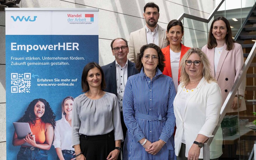Gruppenfoto der Beteiligten mit zwei Männern und fünf Frauen vor EmpowerHer-Rollup