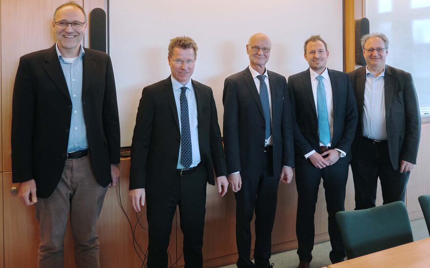 Timm nach seiner Promotionsprüfung mit vier Professoren, alle im schwarzen Anzug