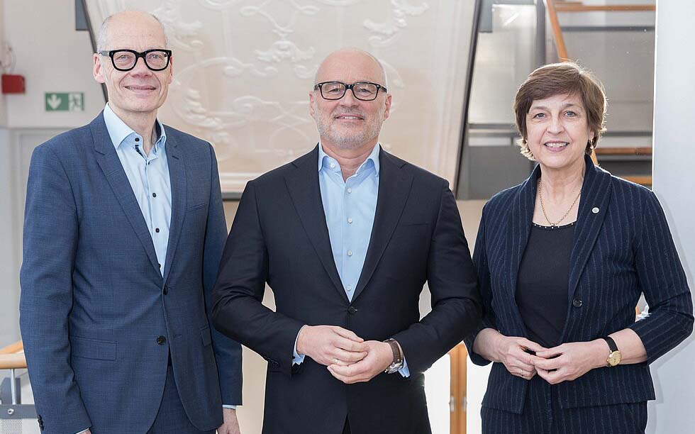 Die beiden Stellvertretenden des neuen Vorsitzenden von Hochschule Bayern stehen rechts und links neben ihm